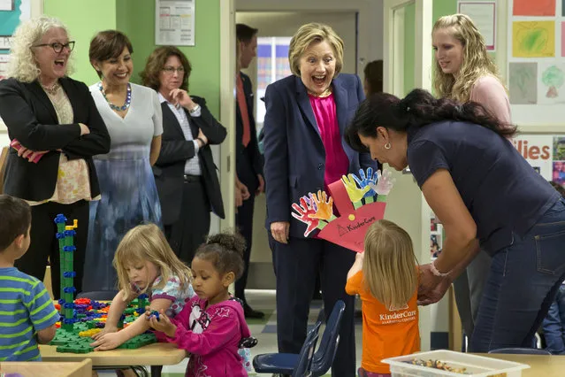 Democratic Presidential Candidate Hillary Clinton reacts as a 3-year-old presents her with her artwork at Lee Highway KinderCare in Fairfax, Va., Monday, May 9, 2016. (Photo by Jacquelyn Martin/AP Photo)