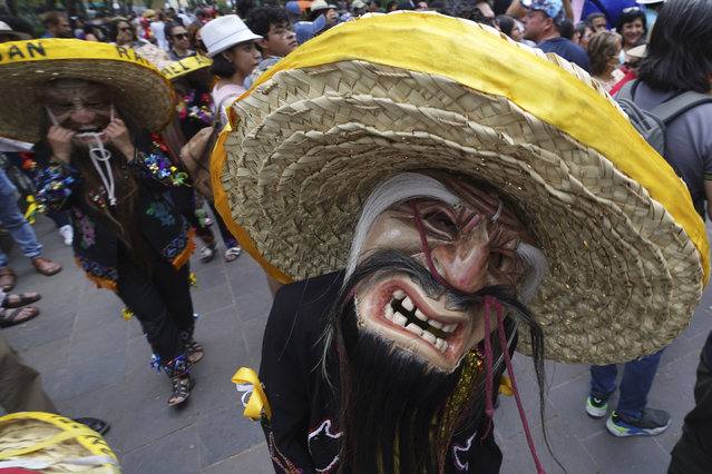 Performers dance the “Danza de los Viejitos” or the “Dance of the Old Ones”, during the Burning of Judas celebrations at the Santa María La Ribera Cultural Center in Mexico City, Saturday, April 8, 2023. The annual celebration takes place in Mexico every Holy Saturday, when people across the country gather in public plazas to light fireworks that will destroy cardboard figures representing symbolic embodiments of evil. (Photo by Marco Ugarte/AP Photo)