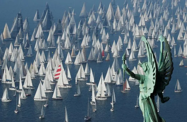 Sailing boats gather at the start of the Barcolana regatta in front of Trieste harbour, Italy, October 13, 2019. (Photo by Alessandro Garofalo/Reuters)