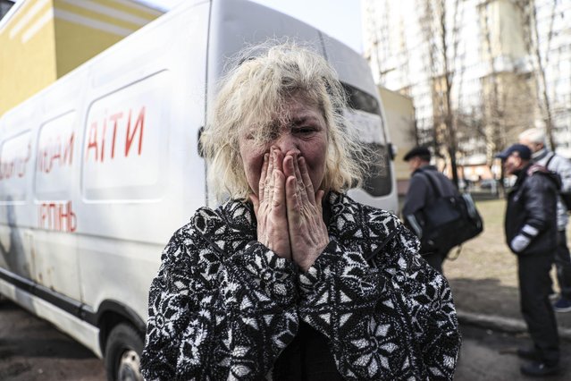 Liana Oleksienko cries as civilians evacuated from Irpin are brought to the center established in the Sviatoshinski district of Kyiv, Ukraine on March 31, 2022. Evacuation of civilians continues in Irpin, near the capital Kyiv amid Russian attacks on Ukraine. (Photo by Metin Aktas/Anadolu Agency via Getty Images)