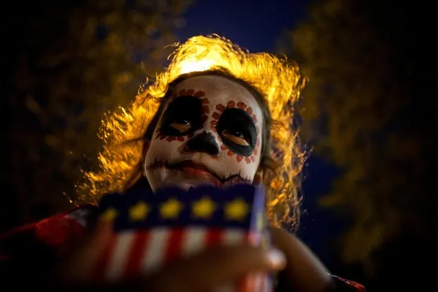 A participant wearing a costume and make-up attends a Halloween party at a village in Bangkok, Thailand, October 31, 2019. (Photo by Athit Perawongmetha/Reuters)