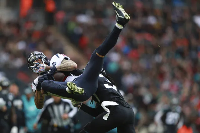 Jacksonville Jaguars cornerback Tre Herndon (37) hits Houston Texans wide receiver Kenny Stills (12) during the first half of an NFL football game at Wembley Stadium, Sunday, November 3, 2019, in London. (Photo by Ian Walton/AP Photo)