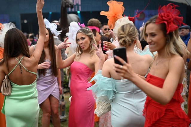 Racegoers attend the second day of the Grand National Festival horse race meeting at Aintree Racecourse in Liverpool, north-west England, on April 14, 2023. (Photo by Oli Scarff/AFP Photo)