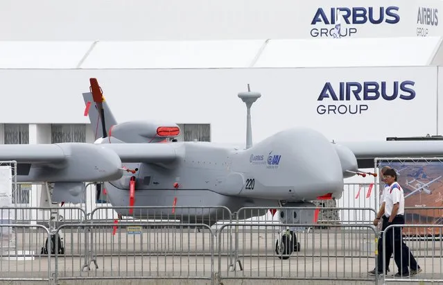 Visitors walk past a surveillance unmanned air vehicle (UAV) 'Heron TP' by IAI and Airbus Defence at the ILA Berlin Air Show in Schoenefeld, south of Berlin, Germany, May 31, 2016. (Photo by Fabrizio Bensch/Reuters)