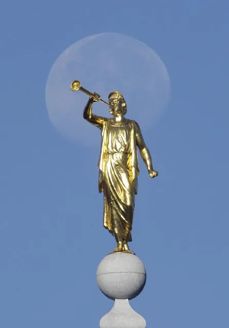 In this September 11, 2014, file photo, the angel Moroni statue sits atop the Salt Lake Temple, at Temple Square, in Salt Lake City. (Photo by Rick Bowmer/AP Photo)