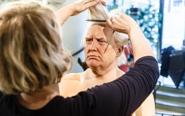 A makeup artist arranges the hair on the waxwork of Donald Trump during the annual clean and repair at the Panoptikum wax museum in Hamburg, Germany on January 27, 2020. (Photo by Markus Scholz/DPA Picture Alliance/Alamy Live News)