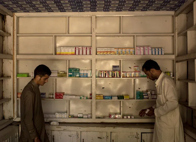 Men restock a pharmacy which had been closed for two years on July 15, 2017 in Shadal Bazaar, Afghanistan. (Photo by Andrew Renneisen/Getty Images)