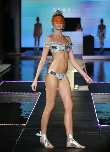 A model walks down the runway wearing Seafolly swimwear at a FUNKSHION fashion show during Swim Week, Sunday, July 23, 2017, in Miami Beach, Fla. (Photo by Lynne Sladky/AP Photo)