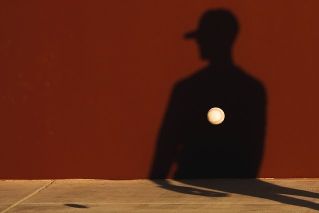 A member of the Seattle Mariners tosses a ball against a wall during drills at spring training baseball workouts, Thursday, February 15, 2024, in Peoria, Ariz. (Photo by Lindsey Wasson/AP Photo)