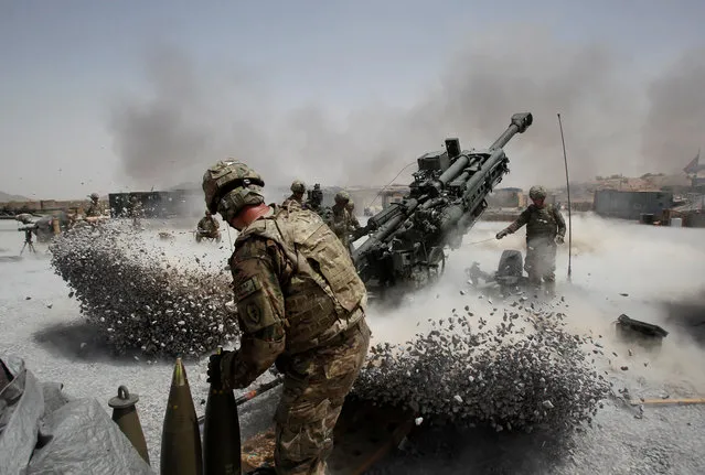 U.S. Army soldiers from the 2nd Platoon, B battery 2-8 field artillery, fire a howitzer artillery piece at Seprwan Ghar forward fire base in Panjwai district, Kandahar province southern Afghanistan, June 12, 2011. (Photo by Baz Ratner/Reuters)