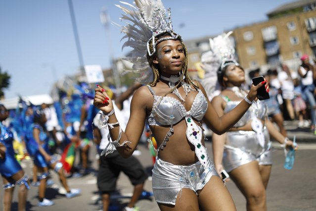 Performers pose on the first day of the Notting Hill Carnival in west London on August 27, 2017. Nearly one million people are expected by the organizers Sunday and Monday in the streets of west London' s Notting Hill to celebrate Caribbean culture at a carnival considered the largest street demonstration in Europe. (Photo by Tolga Akmen/AFP Photo)