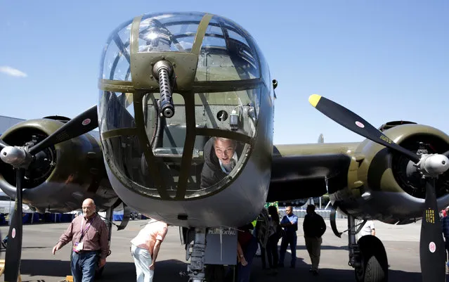 Visitors climb inside a North American Aviation, B-25D Mitchell at an event marking the centennial of The Boeing Company in Seattle, Washington July 15, 2016.  REUTERS/Jason Redmond