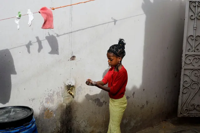 A girl washes her hands at the entrance of her parents' house in Pikine, on the outskirts of Dakar, Senegal March 9, 2020. (Photo by Zohra Bensemra/Reuters)