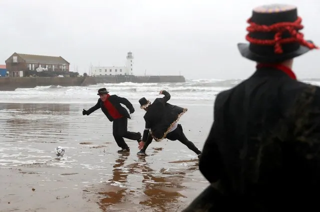 People participate in the Fishermen and Firemen's Boxing Day football match, a major fundraiser for the Fishermen and Firemen's Charity which provides help for the elderly and the infirm during the winter months. The match is believed to be Scarborough's oldest surviving custom, played on the Boxing Day since 1898, on the South Bay Beach in Scarborough, Britain, December 26, 2021. (Photo by Lee Smith/Reuters)