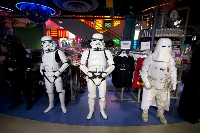 People dressed as Storm Trooper characters from “Star Wars” await people to purchase toys that went on sale at midnight in advance of the film “Star Wars: The Force Awakens” in Times Square in the Manhattan borough of New York, September 4, 2015. (Photo by Carlo Allegri/Reuters)