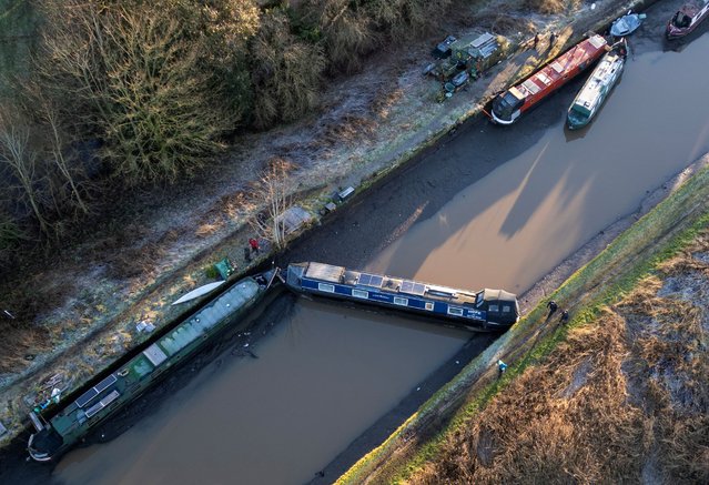 A drone view shows a canal boat lying across the partly drained canal after a section of the Bridgewater Canal embankment collapsed during heavy rain near Little Bollington, Britain, on January 2, 2025. (Photo by Phil Noble/Reuters)