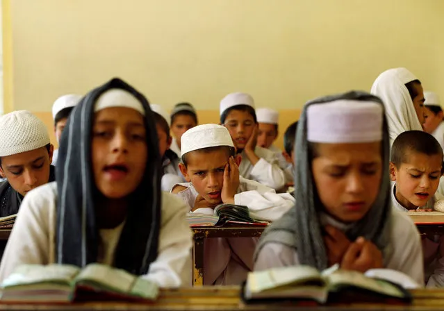 Afghan boys read the Koran in a madrasa, or religious school, during the Muslim holy month of Ramadan in Kabul, Afghanistan May 28, 2017. (Photo by Omar Sobhani/Reuters)