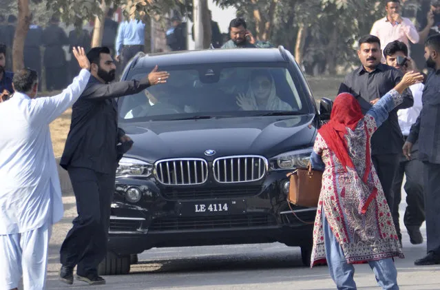 Maryam Nawaz, daughter of former Prime Minister Nawaz Sharif, right front passenger in vehicle, waves upon her arrival at an accountability court in Islamabad, Pakistan, Friday, October 13, 2017. The indictment of Sharif and his daughter and son-in-law on corruption charges has been delayed following clashes between his supporters and police outside the court in Islamabad. (Photo by B.K. Bangash/AP Photo)
