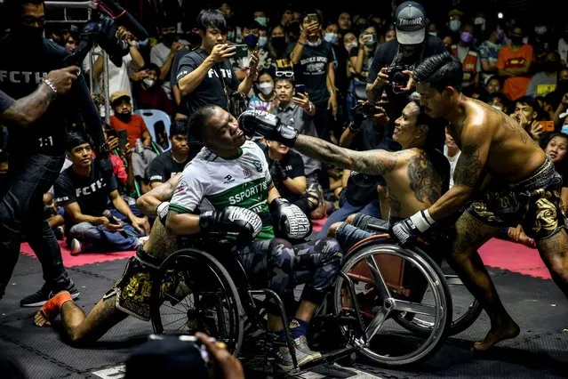 Wheelchair bound amateur fighters, Black Crow (C L) and Podum, throw punches at each other during an underground fighting event by “Fight Club Thailand”, at a temple in Nonthaburi province, on the outskirt of Bangkok, Thailand, 27 August 2022. (Photo by Diego Azubel/EPA/EFE)