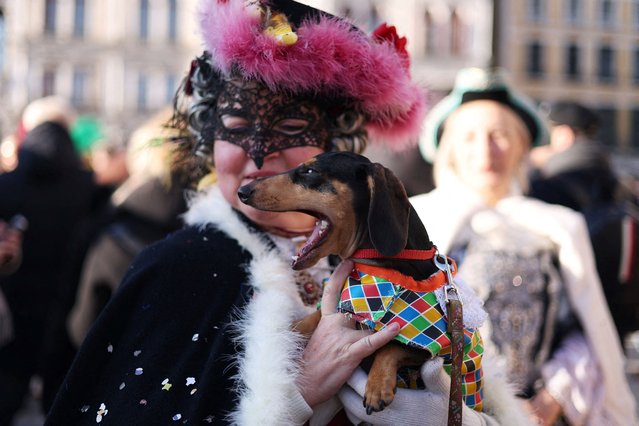 A masked reveller and her dog take part in the Venice carnival at St. Mark's Square in Venice, Italy, on February 16, 2025. (Photo by Claudia Greco/Reuters)