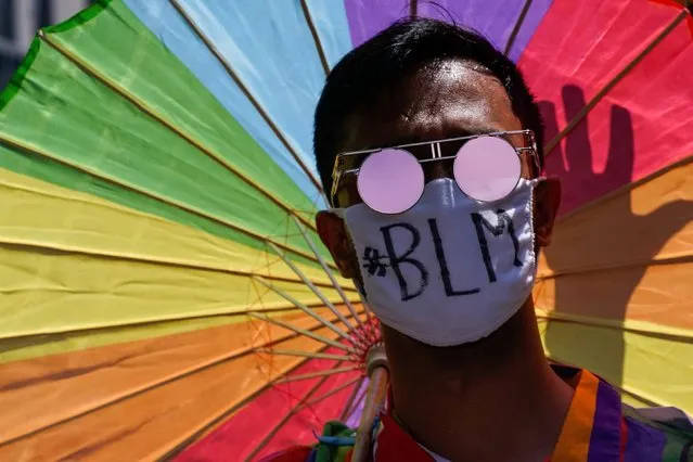 A demonstrator wears a face mask during a joint LGBTQ and Black Lives Matter march on the 51st anniversary of the Stonewall riots in New York City, New York, U.S. June 28, 2020. (Photo by Eduardo Munoz/Reuters)