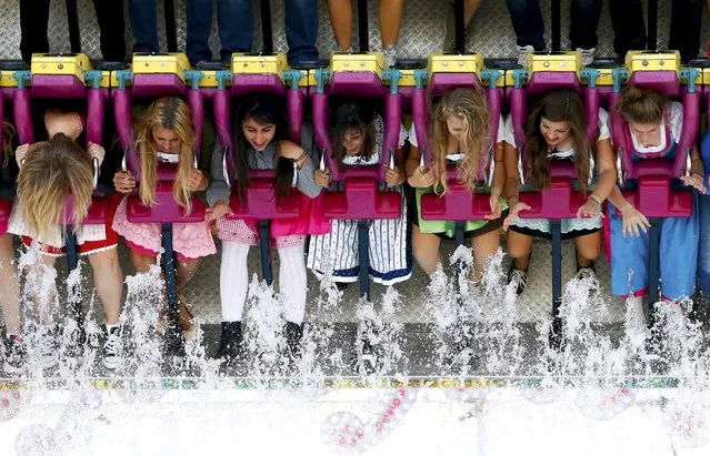 Visitors enjoy a “Topspin” fun ride during the opening day of the 182nd Oktoberfest in Munich September 19, 2015. (Photo by Michaela Rehle/Reuters)