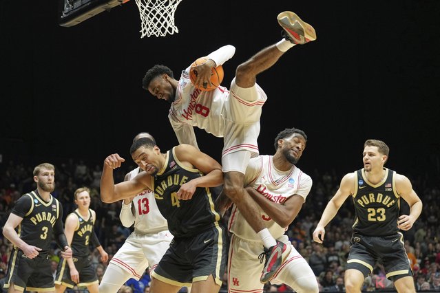 Houston's Mylik Wilson (8) falls over Purdue's Trey Kaufman-Renn (4) while reaching for a ball during the second half in the Sweet 16 of the NCAA college basketball tournament Friday, March 28, 2025, in Indianapolis. (Photo by AJ Mast/AP Photo)