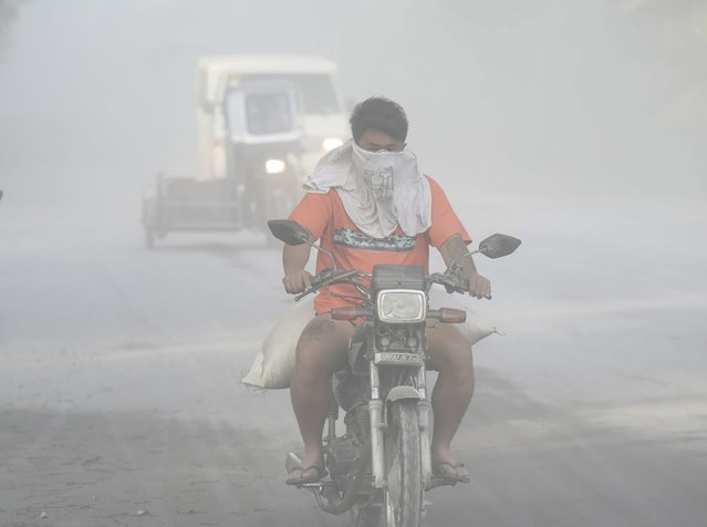 A handout photo made available by the Sorsogon Provincial Information Office (SPIO) shows motorists maneuvering along a road covered with volcanic ash from the Bulusan volcano, in the town of Juban, Sorsogon province, Philippines, 28 April 2025. The Bulusan Volcano in Sorsogon province, about 570 kilometers south of Manila, erupted on 28 April, according to the Philippine Institute of Volcanology and Seismology (Phivolcs) and its plumes reached 4,500 meters high. (Photo by SPIO/EPA)