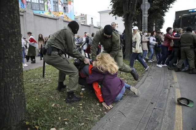 Police officers detain a woman during a rally in support of Maria Kolesnikova, a member of the Coordination Council created by the opposition to facilitate talks with Lukashenko on a transition of power, was detained Monday in the capital of Minsk with two other council members, in Minsk, Belarus, Tuesday, September 8, 2020. A leading opposition activist in Belarus is being held on the border with Ukraine after she resisted attempts by authorities to deport her from the country as part of a clampdown on protests against authoritarian President Alexander Lukashenko. (Photo by AP Photo/Stringer)