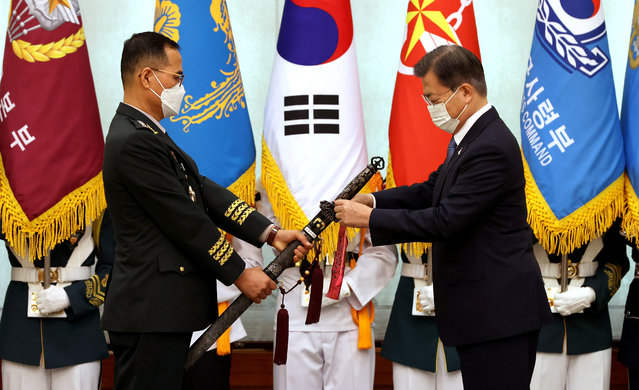 South Korea's President Moon Jae-in (R) ties a tassel onto the sword of Gen. Nam Yeong-shin, new Army Chief of Staff, during his inauguration ceremony at the presidential office Cheong Wa Dae in Seoul, South Korea, 23 September 2020. The traditional Korean sword, Sam Jeong Geom, or the Three Spirits Sword, represents the defense of the country, unification and prosperity, as well as the Army, Navy and Air Force. The tassel bears the recipient's post, inauguration date and the president's name in Korean. (Photo by Yonhap/EPA/EFE/Rex Features/Shutterstock)