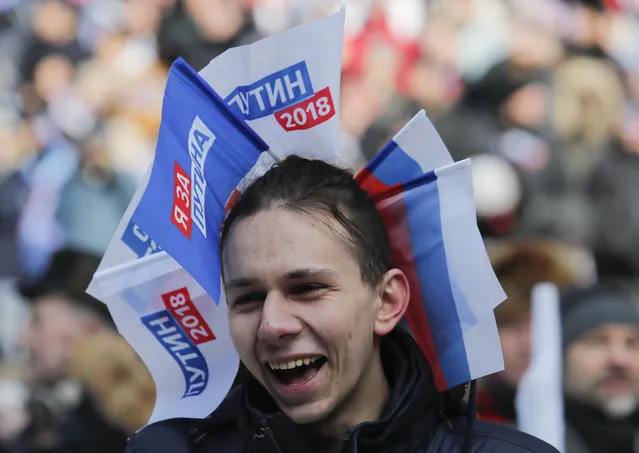 A youth takes part in a rally to support Russian President Vladimir Putin in the upcoming presidential election at Luzhniki Stadium in Moscow, Russia, March 3, 2018. (Photo by Maxim Shemetov/Reuters)