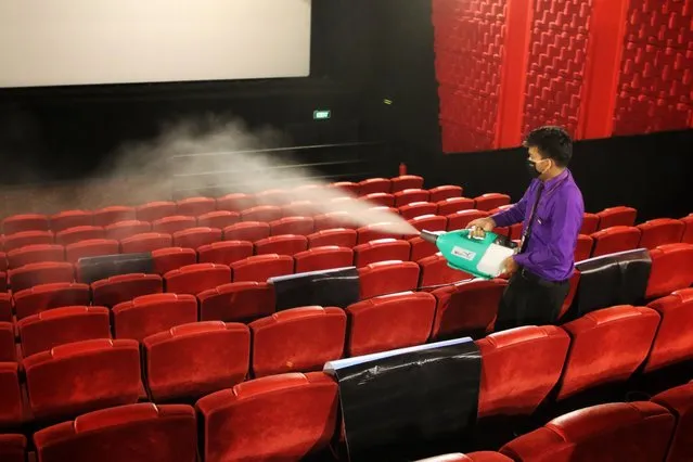 A staff member is seen disinfecting inside a movie theater ahead of its reopening after the government eased isolation measures to prevent the spread of the Coronavirus disease (COVID-19) in Dhaka, Bangladesh on October 23, 2020. After being closed for about seven months due to the Coronavirus epidemic, the cinema hall finally reopen in Dhaka. (Photo by Sultan Mahmud Mukut/SOPA Images/Rex Features/Shutterstock)
