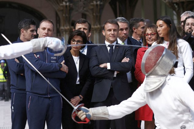 French President Emmanuel Macron with French fencing champion Sara Balzer and Minister of Culture of France Rachida Dati attends a demonstration by the French fencing team during his visit to the Grand Palais, 100 days ahead of the Paris 2024 Olympic Games in Paris, France on April 15, 2024. (Photo by Yoan Valat/Pool via Reuters)