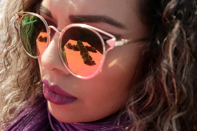 A mock coffin is reflected in the glasses of an activist during a protest to mark International Women's Day at a memorial for women murder victims in Ciudad Juarez, Mexico March 7, 2018. (Photo by Jose Luis Gonzalez/Reuters)