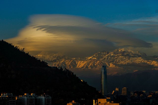 Clouds hover over the Andes Mountains in Santiago, Chile, Wednesday, June 19, 2024. (Photo by Esteban Felix/AP Photo)