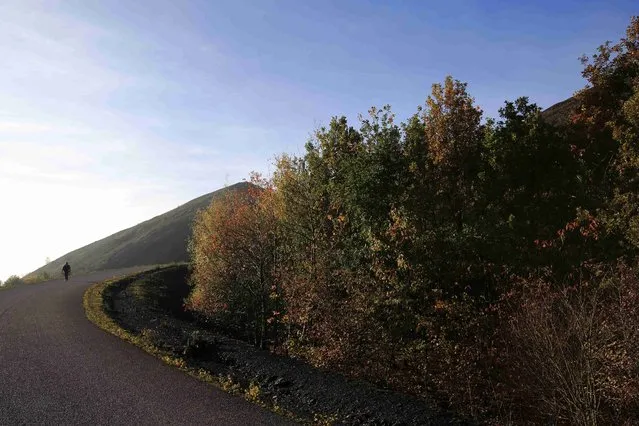A hiker is seen on the road of the 11/19 pit and twin slag heaps at the former coal mine site in Loos-en-Gohelle, northern France, October 31, 2015. (Photo by Pascal Rossignol/Reuters)