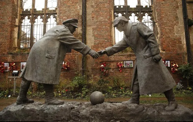 A resin sculpture, called “All Together Now”, by artist Andrew Edward's is seen after being unveiled in the remains of St Luke's Church in Liverpool, northern England December 15 , 2014. The sculpture, depicting the Christmas Day football match between German and British soldiers fighting on the front line in World War One in 1914, will be displayed in the church that was damaged during German bombing of Liverpool in 1941. (Photo by Phil Noble/Reuters)