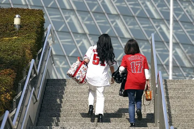 Fans of Japan's Shohei Ohtani walk toward the Tokyo Dome prior to the Pool B game between Japan and China at the World Baseball Classic (WBC) at the Tokyo Dome Thursday, March 9, 2023, in Tokyo. (Photo by Eugene Hoshiko/AP Photo)