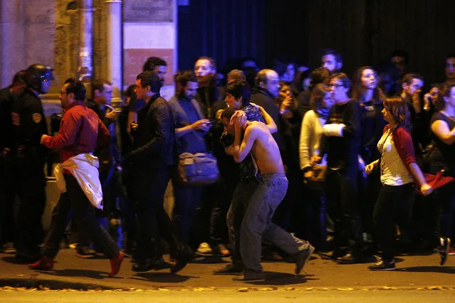 Wounded people are evacuated outside the scene of a hostage situation at the Bataclan theatre in Paris, France, November 14, 2015. (Photo by Yoan Valat/EPA)