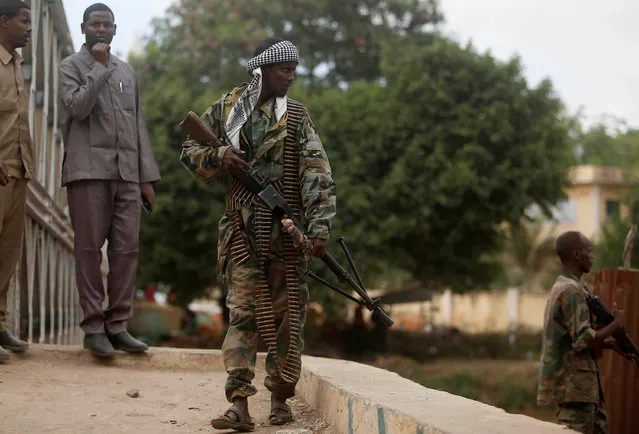 A Somali soldier patrols a street near a bridge following a suicide car bomb and gun attack on Tuesday that killed 11 people in Afgoye, Somalia, October 19, 2016. (Photo by Feisal Omar/Reuters)