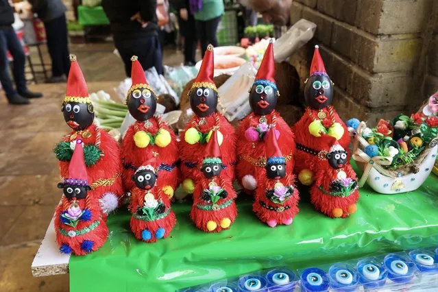 In this picture taken on March 14, 2023, figures of the fictional folklore character Hajji Firuz are displayed at a stall in Tehran ahead of the Nowruz New Year festival. Tehran is emptying ahead of the Persian New Year, as is the case annually, but this time around Iranians are being forced to adapt as the festival coincides with Ramadan. (Photo by Atta Kenare/AFP Photo)