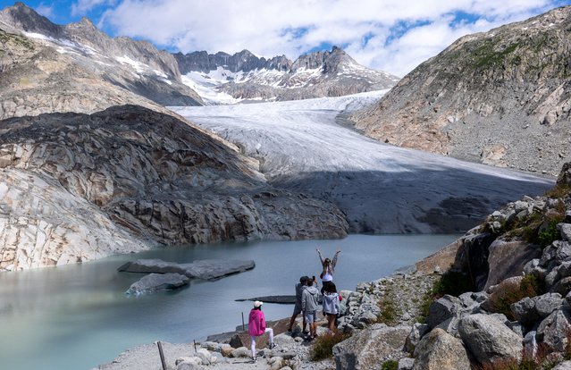 Tourists take pictures in front of the Rhone glacier, amid climate change in Obergoms, Switzerland, on July 12, 2025. (Photo by Denis Balibouse/Reuters)