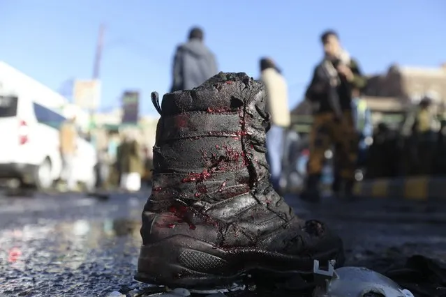 A boot is seen covered with blood splatter at the scene of a car bomb attack at the police college in Sanaa January 7, 2015. A car bomb exploded outside a police college in Yemen's capital Sanaa early on Wednesday, killing around 30 people and wounding more than 50 others, police sources and residents said. (Photo by Mohamed al-Sayaghi/Reuters)