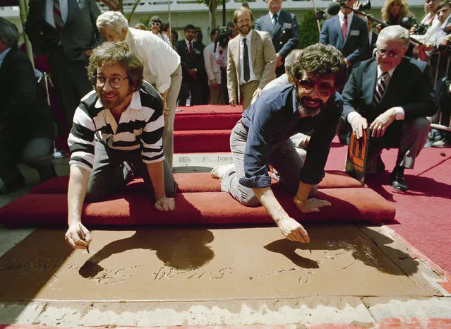 Moviemakers Steven Spielberg, left, and George Lucas , the two men responsible for the six most popular films of all time sign their names in cement Wednesday, May 16, 1984 during festivities at Mann 's Chiness theatre in Hollywood. (Photo by Wally Fong/AP Photo)