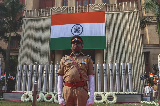 Indian police personnel pay tribute at the memorial built in memory of the victims, on the 17th anniversary of the 2008 Mumbai Terror Attacks, at Mumbai Police headquarters in Mumbai, India, 26 November 2025. Around 170 people were killed and more than 300 others were injured when 10 heavily-armed Islamist militants stormed the city on 26 November 2008, attacking a number of sites, including the Chhatrapati Shivaji Maharaj Terminus railway station, as well as the two luxury hotels: Taj Mahal Palace and Oberoi, the popular tourist restaurant Leopold Cafe and the Jewish centre Chabad House. (Photo by Divyakant Solanki/EPA)