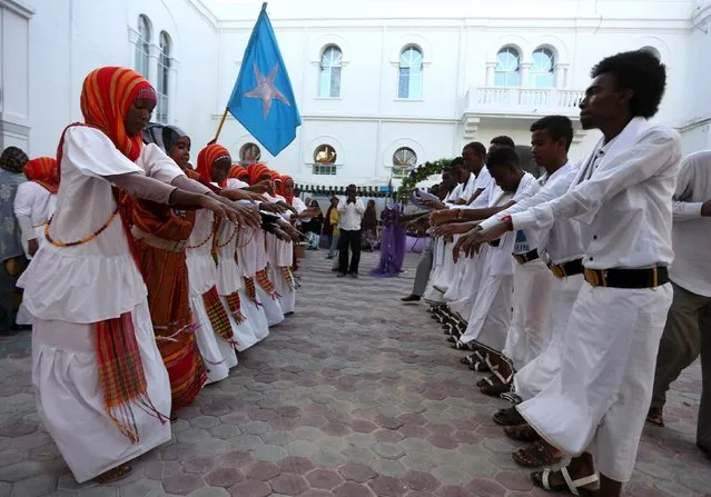 Somali men and women perfom a dance during an event to showcase traditional Somali culture in Hamarweyne district in the capital Mogadishu, December 3, 2015. (Photo by Feisal Omar/Reuters)