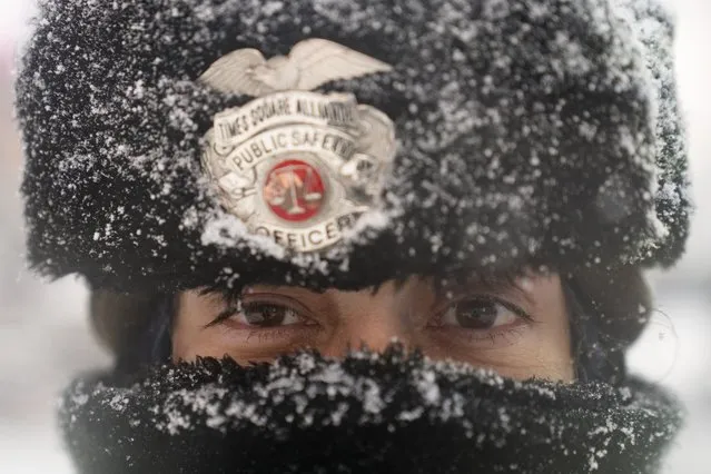 Times Square Alliance security officer Margarita Torres walks in a snowstorm, Monday, February 1, 2021, in New York. (Photo by John Minchillo/AP Photo)