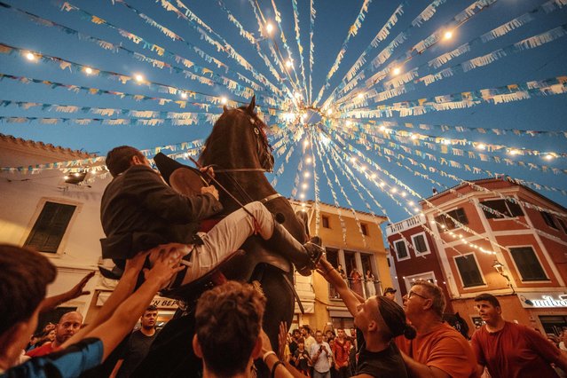 A “caixer” (horse rider) rears up on his horse surrounded by a cheering crowd during the traditional “Jaleo” at the Sant Nicolau Festival in Es Mercadal, Spain on September 14, 2024. (Photo by Matthias Oesterle/Alamy Live News)