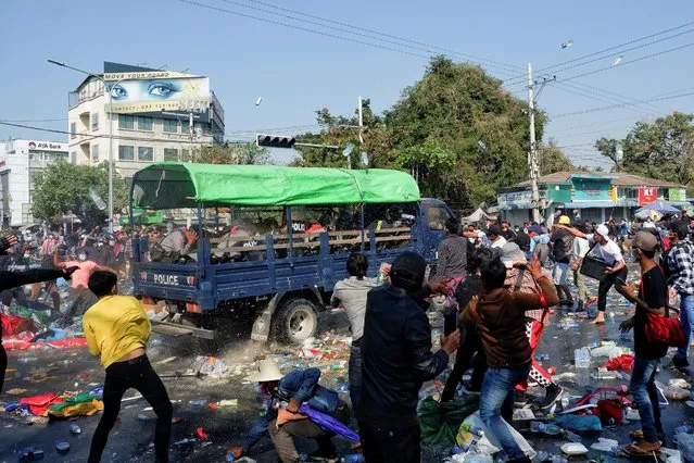 Demonstrators riot against police as they protest against the military coup, in Mandalay, Myanmar, February 9, 2021. (Photo by Reuters/Stringer)