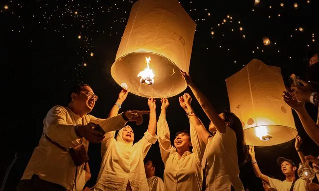 Buddhist devotees and tourists release lanterns into the air on Borobudur temple during celebrations for Vesak Day on June 4, 2023 in Magelang, Central Java, Indonesia. Vesak is observed during the full moon in May or June with the ceremony centering around three Buddhist temples, pilgrims walk from Mendut to Pawon, ending at Borobudur. The holy day celebrates the birth, the enlightenment to nirvana, and the passing of Gautama Buddha's, the founder of Buddhism. (Photo by Ulet Ifansasti/Getty Images)
